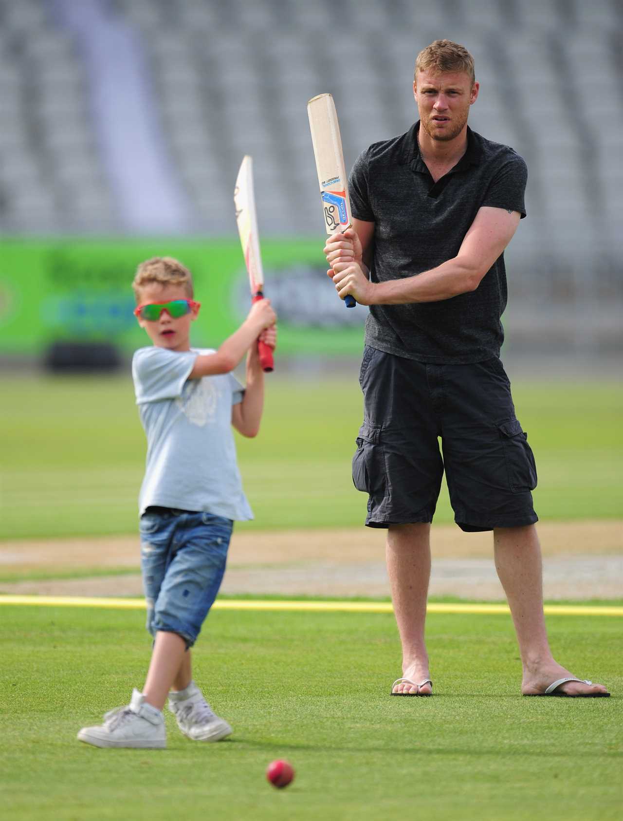 Andrew Flintoff and his son playing cricket.